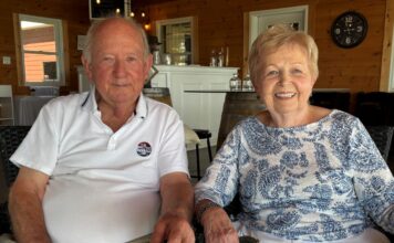 un homme et une femme assis se tenant la main